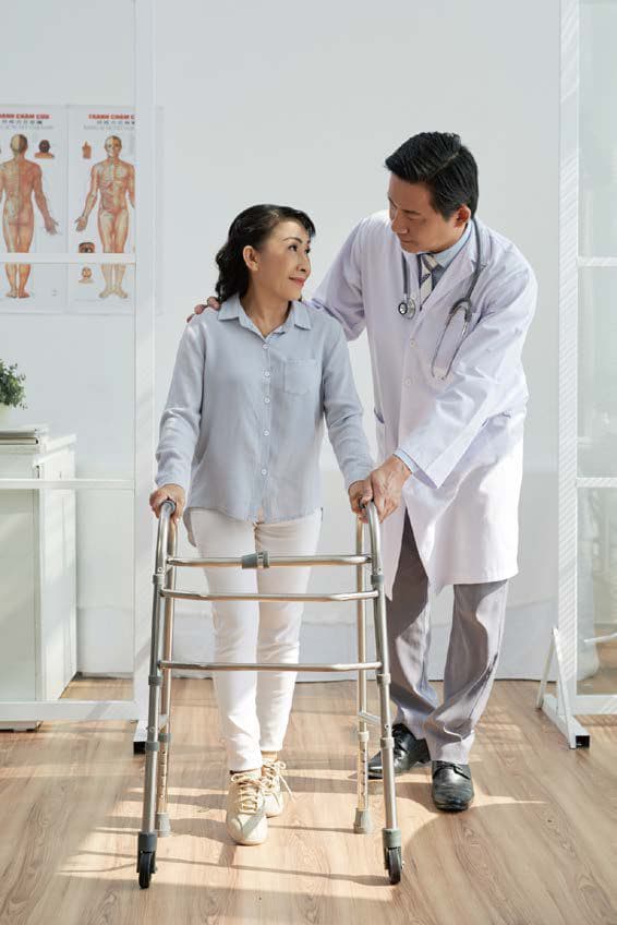 Caregiver supporting a patient while walking — warm documentary photography